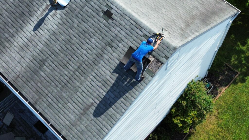 community pro roofer installing roof shingles