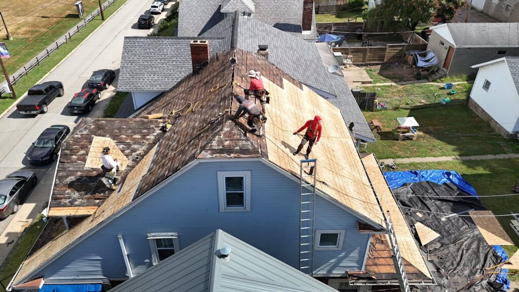 roofers installing asphalt shingle roof